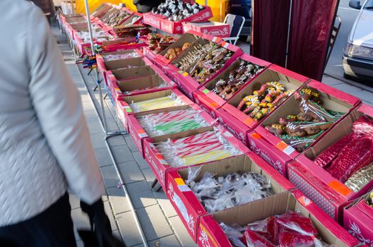 BIRZAI, LITHUANIA - OCTOBER 05: various sweets and candies on sale at market fair bazaar and people customers on October 05, 2013 in Birzai.