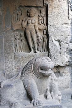 Statue of a lion guarding the entrance to the Hindu rock temple (Sita Ki Nahani), part of the Ellora Caves site in India