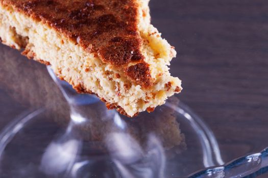 Cake slice in the middle of a glass cake stand