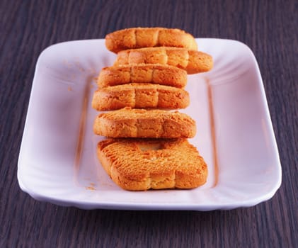 A row of biscuits over a white plate