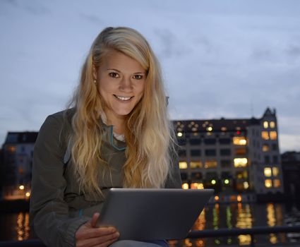 pretty young  woman with tablet computer in the city