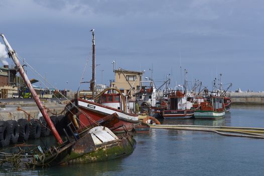 Fishing boats tied up alongside at the fishing port of Lamberts Bay in the Western Cape of South Africa