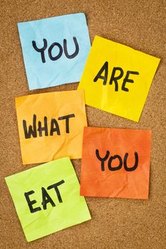 healthy lifestyle concept - you are what to eat reminder words handwritten of sticky notes