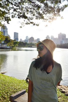Fashion girl at lumpini park in Bangkok, sunset time
