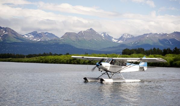 A bush plane performs taxi in in Alaska with Chugach Mountains in the Background