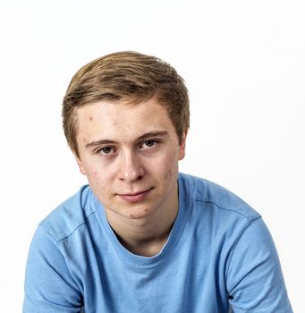 cool boy with blue shirt posing in studio