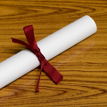 diploma on wood background