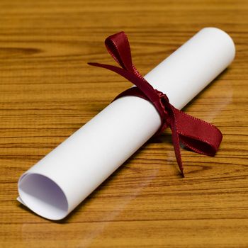 diploma on wood background