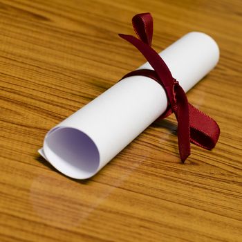 diploma on wood background