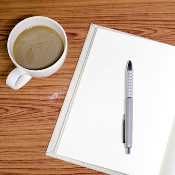 coffee and notebook on wood background concept coffee time