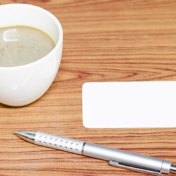 coffee cup and business card on wood background
