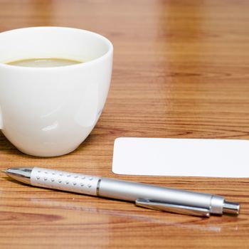 coffee cup and business card on wood background