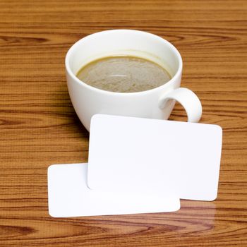 coffee cup and business card on wood background