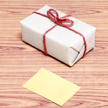 brown gift box and card on wood background