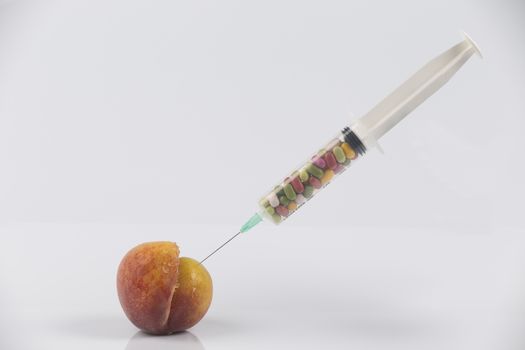 Female menopause and sexual disease metaphor: peach and syringe with meaning cosmetic and health treatment for female ageing