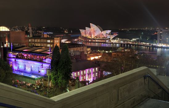 THE ROCKS, SYDNEY, NSW, AUSTRALIA - JUNE 4, 2014;  View of Sydney Harbour and The Rocks by night during Sydney Vivid festival.  Nightscape Long exposure.  Motion in some parts