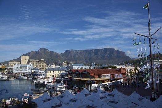 Historic buildings and restaurants in the Victoria and Albert Waterfront in Cape Town in South Africa. Table Mountain in the background.