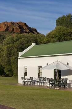 Farm cottage built in traditional Cape architectural style set in landscaped grounds in the Oudtshoorn region of the Western Cape in South Africa
