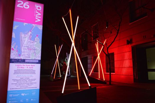 THE ROCKS, SYDNEY, AUSTRALIA - JUNE 6, 2014; Venture at Vivid /Sydney, teepee structures in an alley, memories of childhood tents, where you used to play, hide, scheme and dream. Made of LED light tubes, programmed to flicker so that each pole is illuminated at different times, colours and speeds when people walk by
