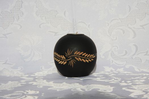 Black wooden decorative candleholder on the table