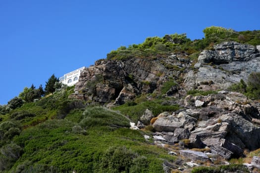 House on the rocks on the coast of Greek island Skopelos