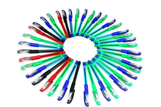 Black, green, red, blue pens laid out in the form of the sun