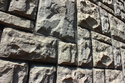 The rectangular and square gray stone slabs decorated fence