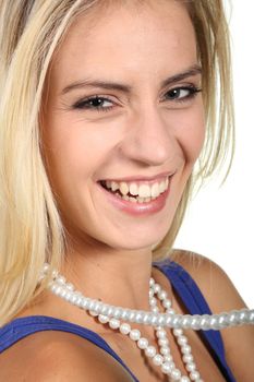 Beautiful smiling blond lady with a string of pearls on white background