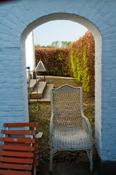 Traditional stone built arch gate leading into a beautiful garden