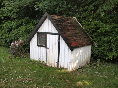 Small play house in a lovely green garden