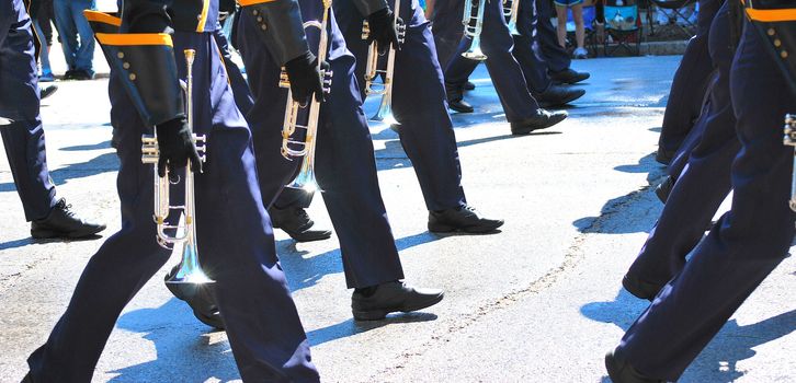 Marching band performing in a parade downtown.