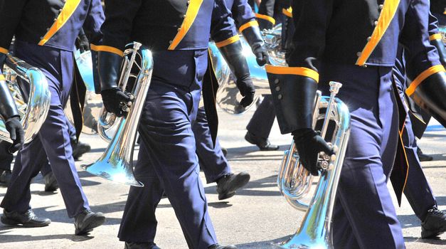Marching band performing in a parade downtown.