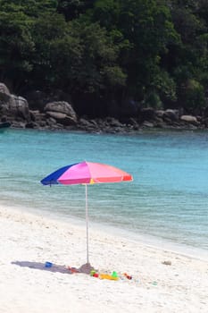 Beach umbrella on a sunny day, sea in background