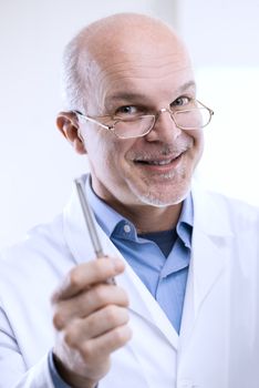 Friendly senior doctor giving advices and smiling.