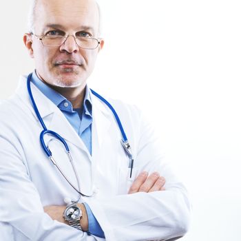 Senior confident doctor in a clinic with arms crossed.
