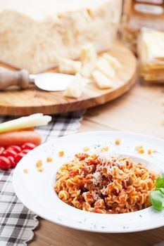 Italian food: pasta with tomato sauce and parmesan cheese.