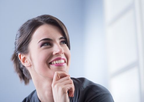 Attractive young woman smiling and looking up.