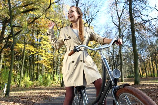 beautiful girl in a hat on a background of autumn alley