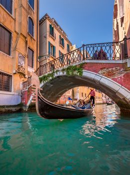 VENICE, ITALY - MARCH 8: Tourists on a Gondola on March 8, 2014 in Venice, Italy. The city has an average of 50,000 tourists a day and it's one of the world's most internationally visited city.