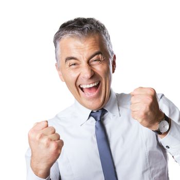 Cheering happy businessman with fists raised on white background.