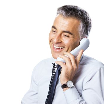 Attractive confident businessman talking on the phone on white background.