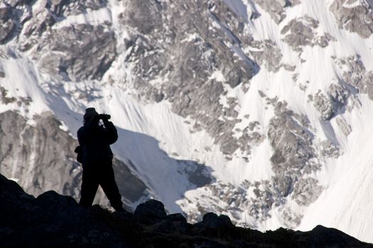Silhouette of a man on the lookout for wildlife high in the Himalaya Mountains of Nepal