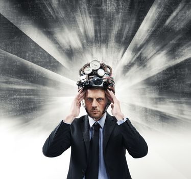 Confident businessman thinking with head in hands wearing steampunk helmet 