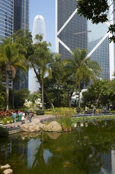 Modern architecture of the financial district towers above a city park in Hong Kong, China