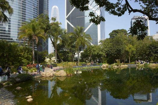 Modern architecture of the financial district towers above a city park in Hong Kong, China