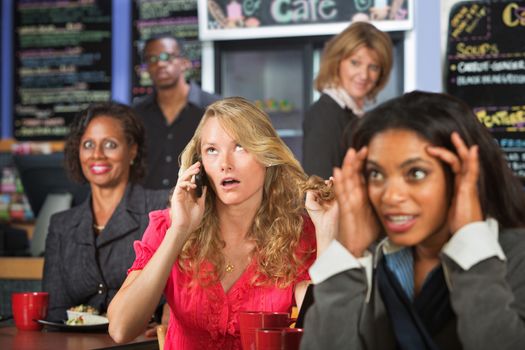 Loud blond woman on cell phone in restaurant