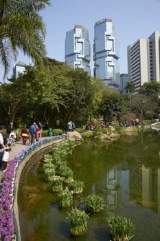 Modern architecture of the financial district towers above a city park in Hong Kong, China