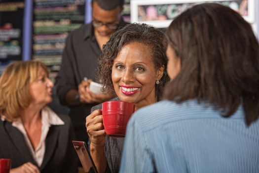 Beautiful business woman holding red coffee mug