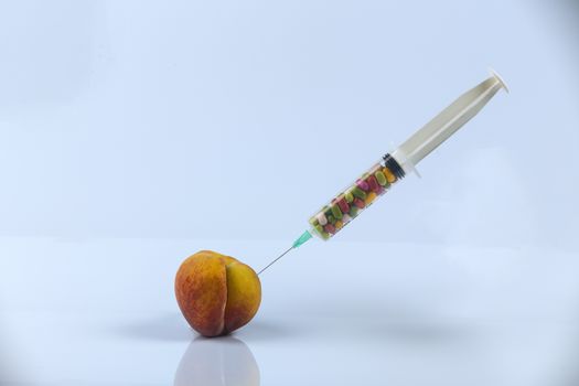 Female menopause and sexual disease metaphor: peach and syringe with meaning cosmetic and health treatment for female ageing