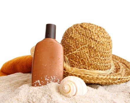 Straw hat with towel and suntan lotion on white background
